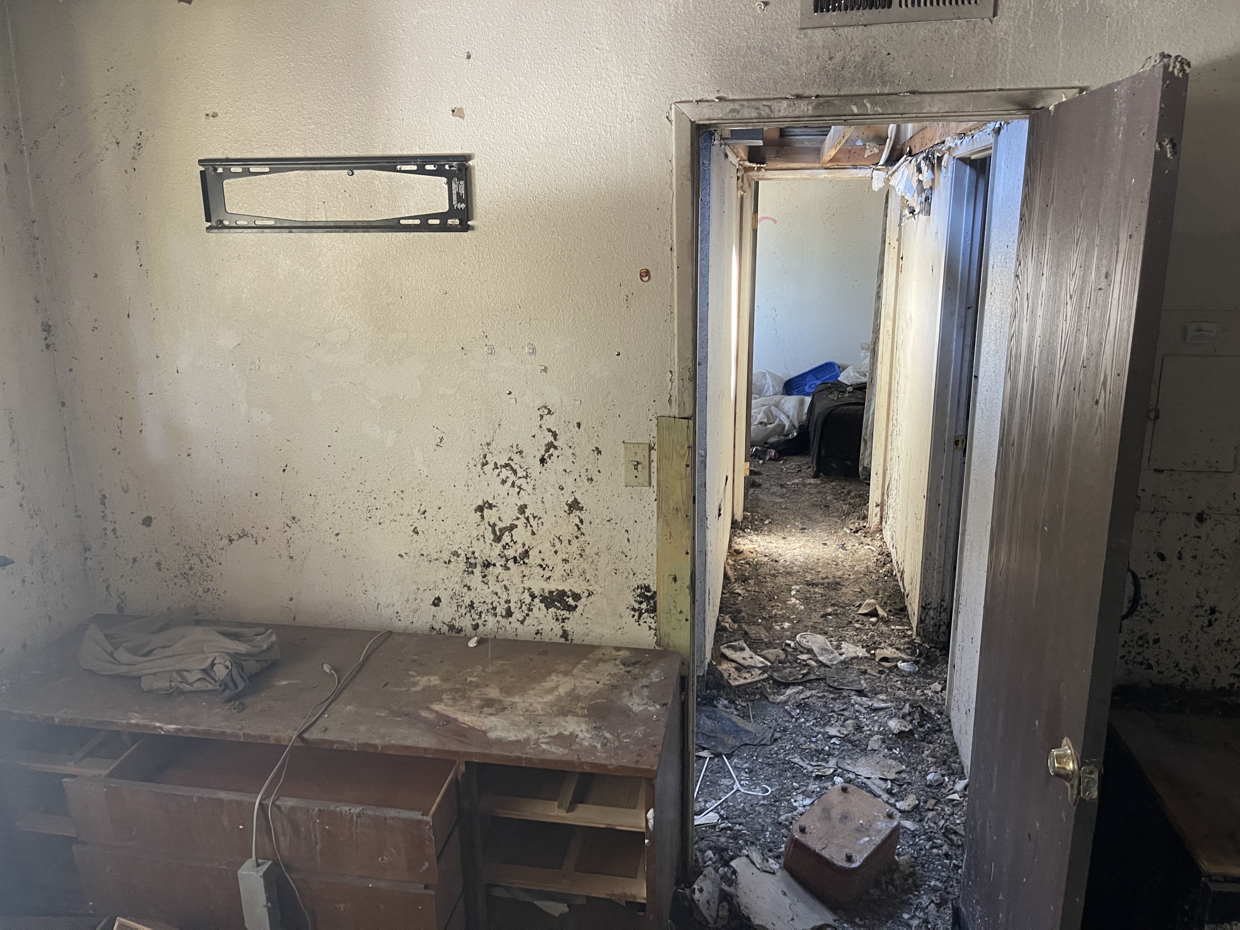 Upstairs view of unit, damaged from fire and fire crews Photo