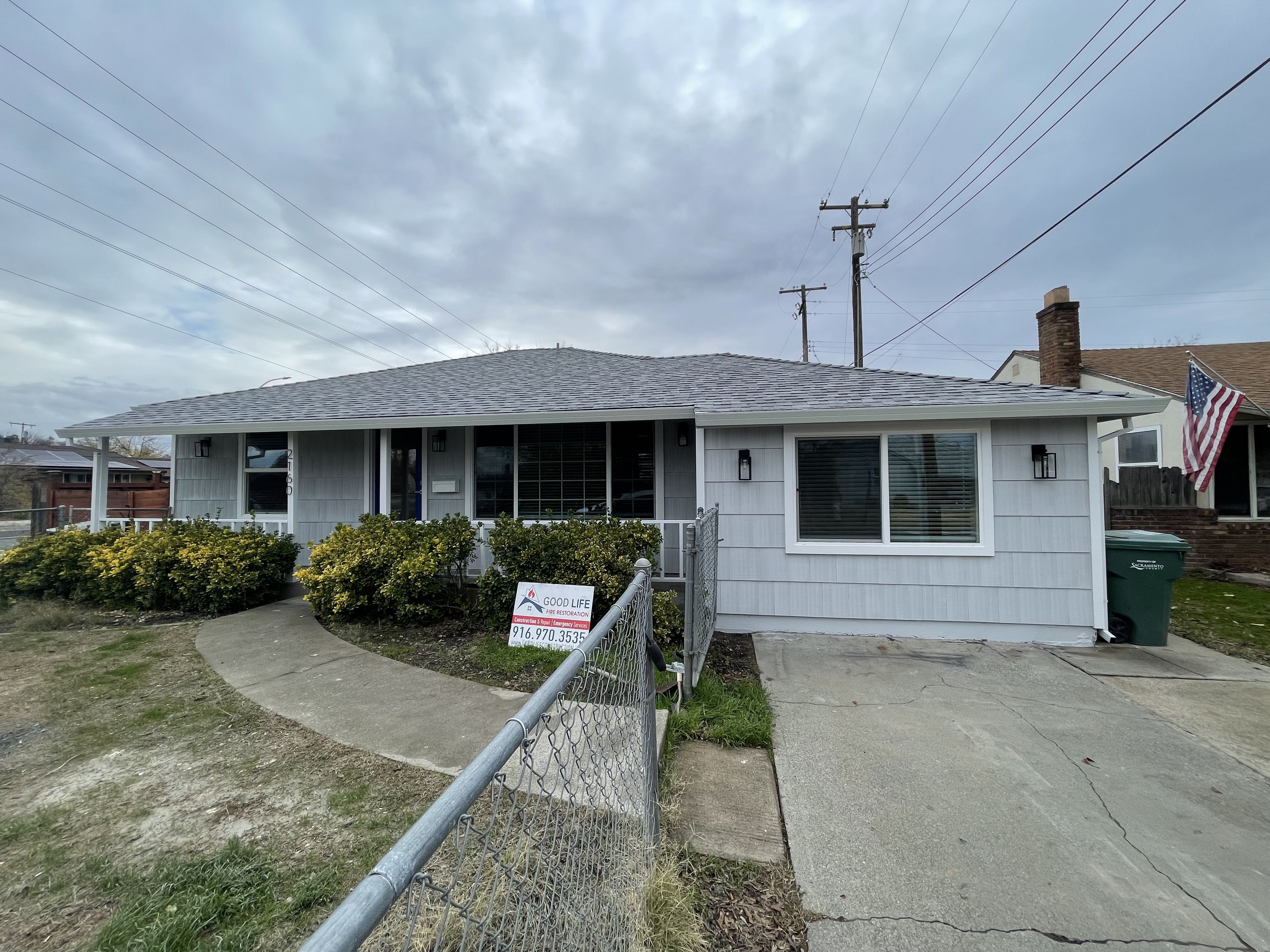 After Front,  Repaired Siding, Roof, Door, Windows and Paint. Photo