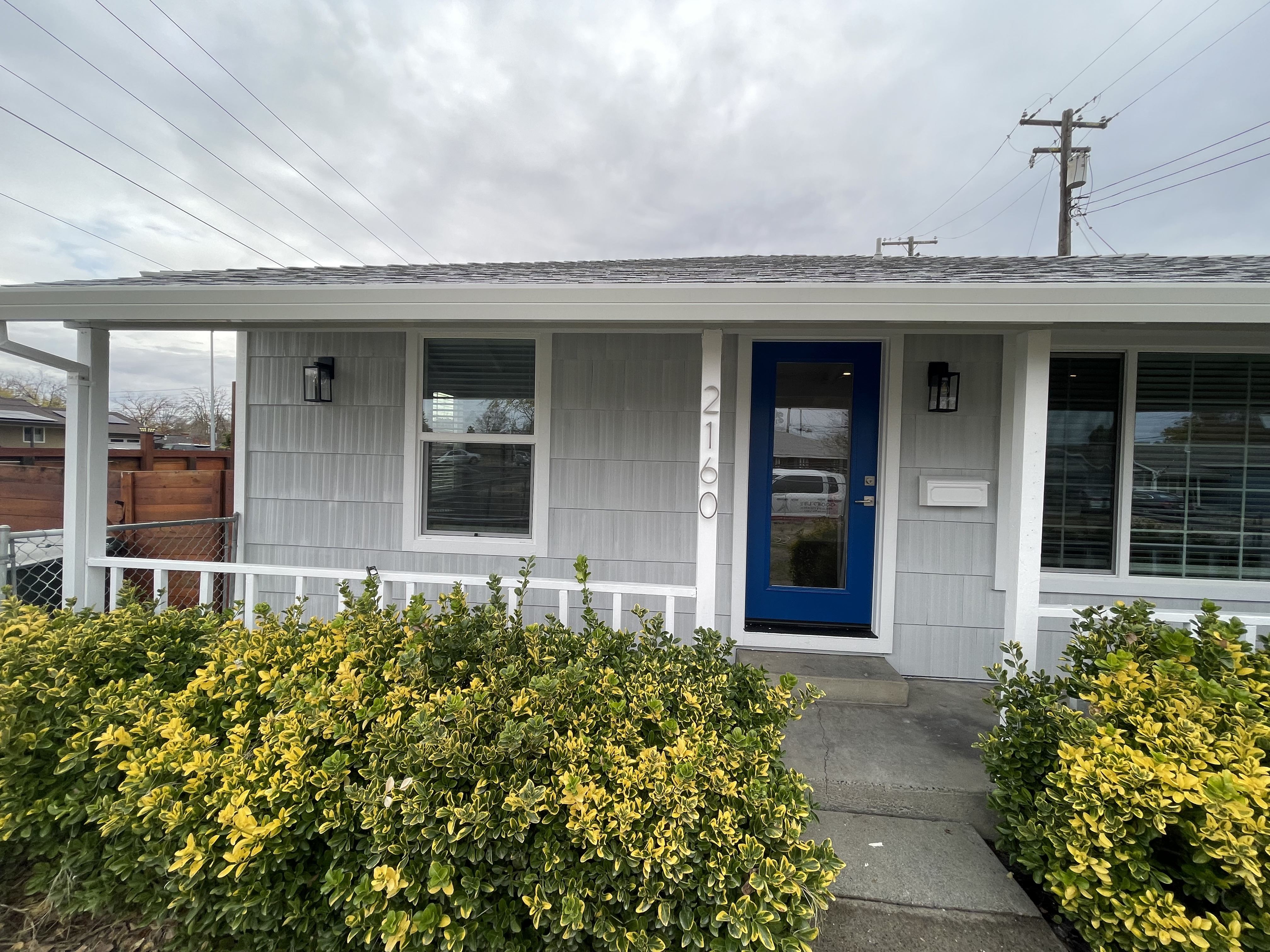 After Front,  Repaired Siding, Roof, Door, Windows and Paint. Photo