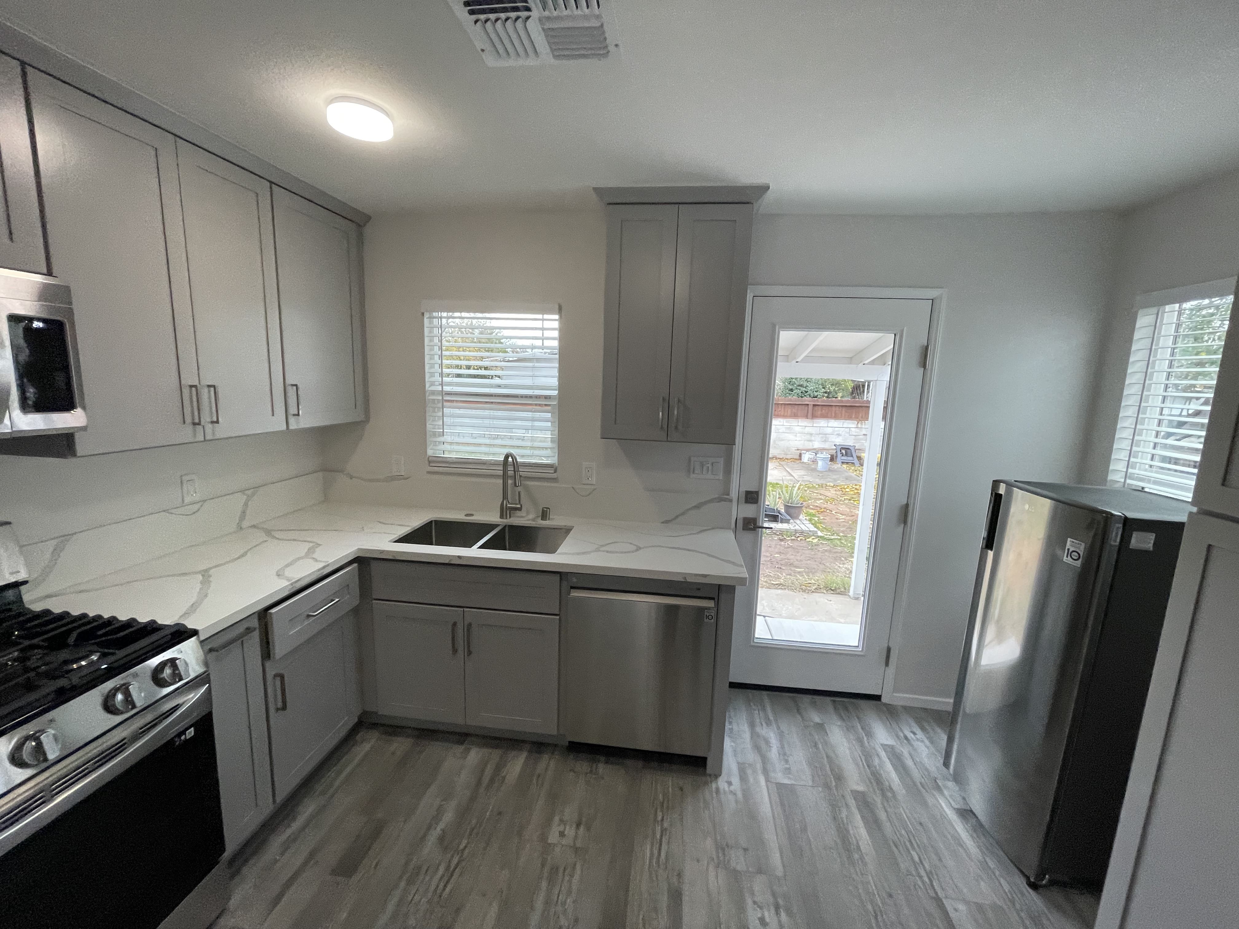 After Interior Kitchen, Repaired Walls, Floors, Kitchen, Electrical, Doors, etc. Photo